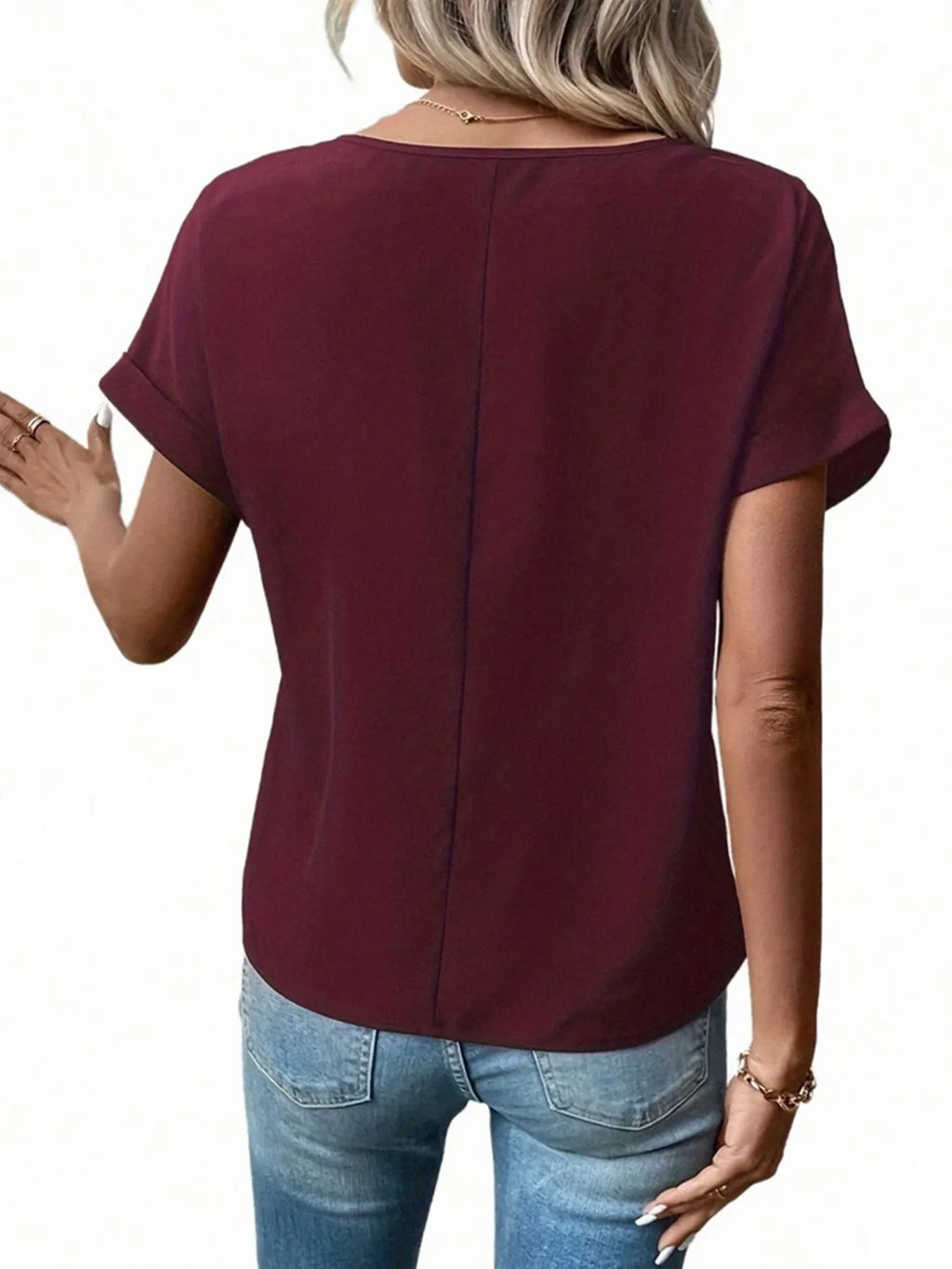 Back view of burgundy short-sleeve zipper blouse with center seam detail