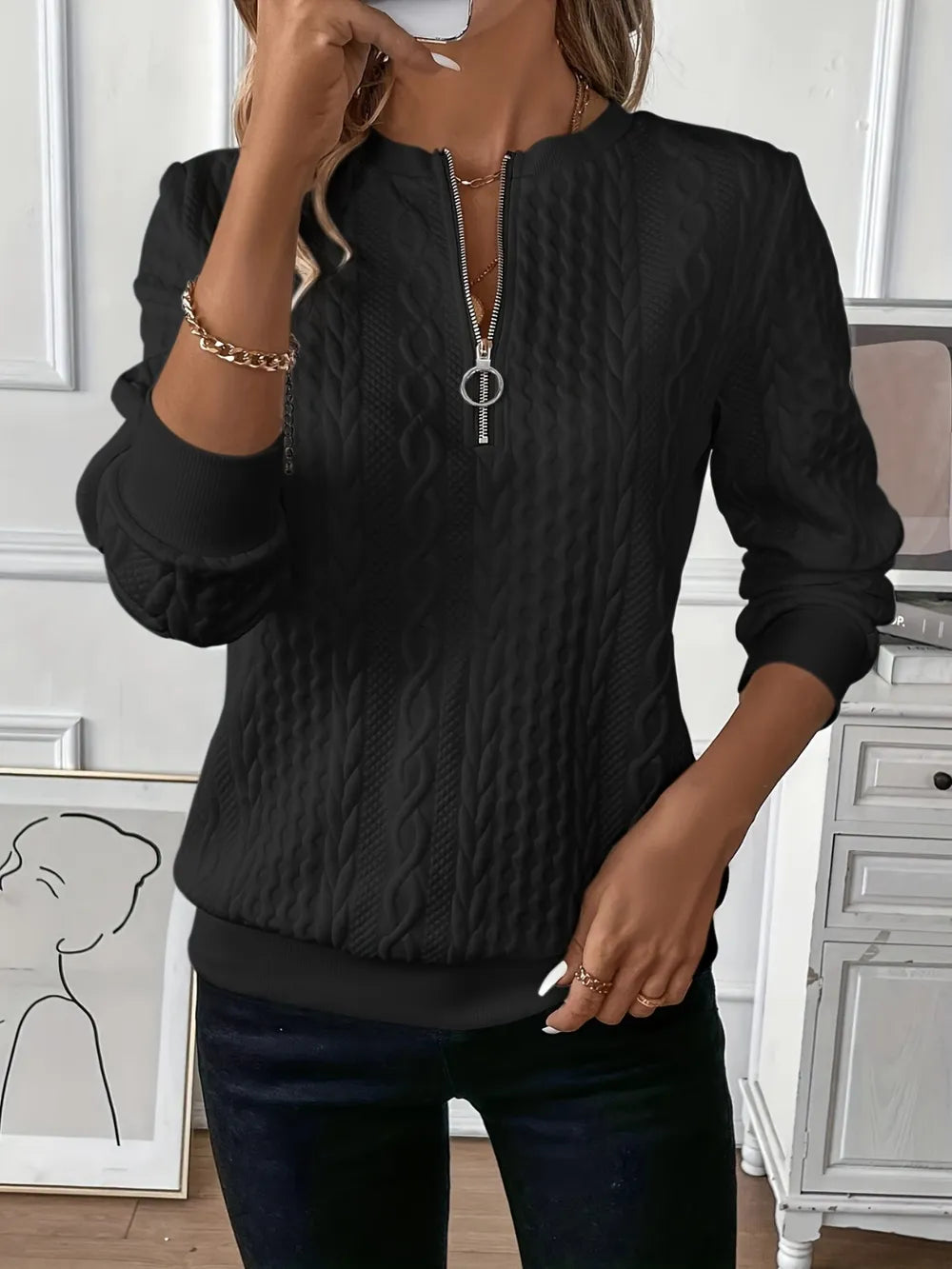 Black textured half-zip long-sleeve sweatshirt with ribbed cuffs and hem