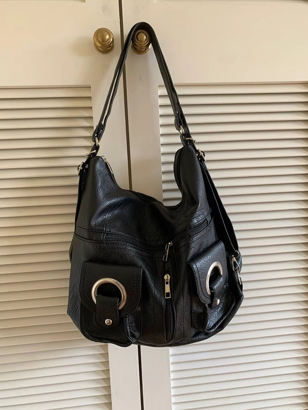 Convertible pocket handbag, black; open top with long handles and front zip pocket