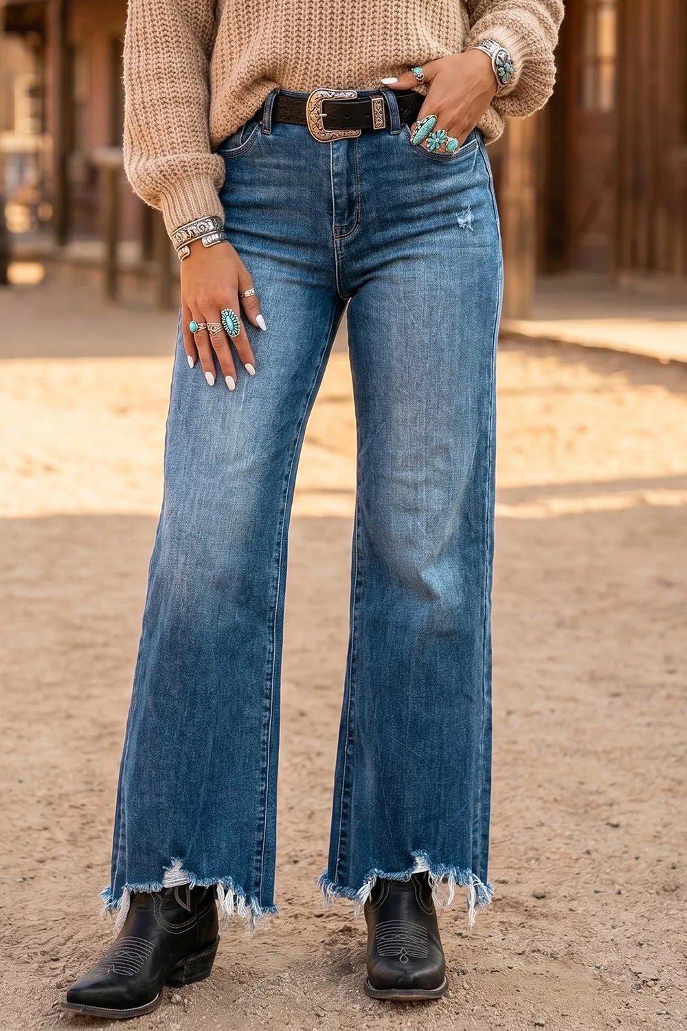 Medium wash high-waist flare jeans with distressed frayed bottom hem