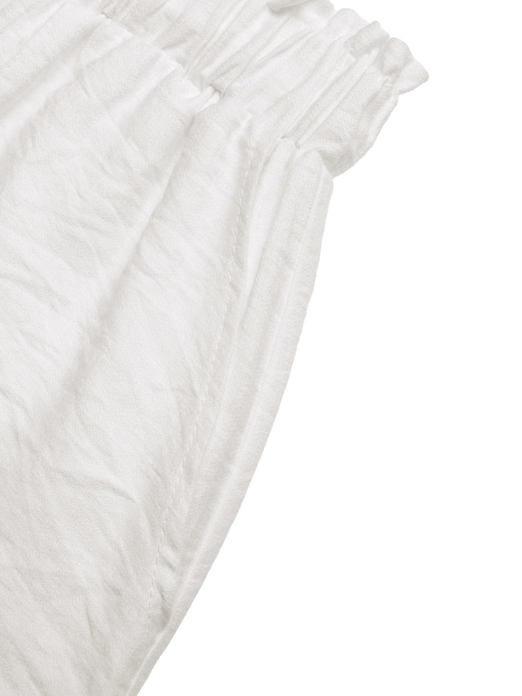 Ivory shorts side view showing gathered waist and lightly textured fabric