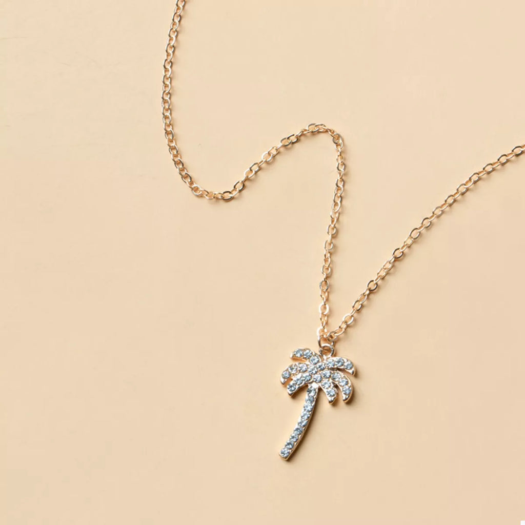 Silver palm tree pendant with blue gemstone accents on a fine link chain