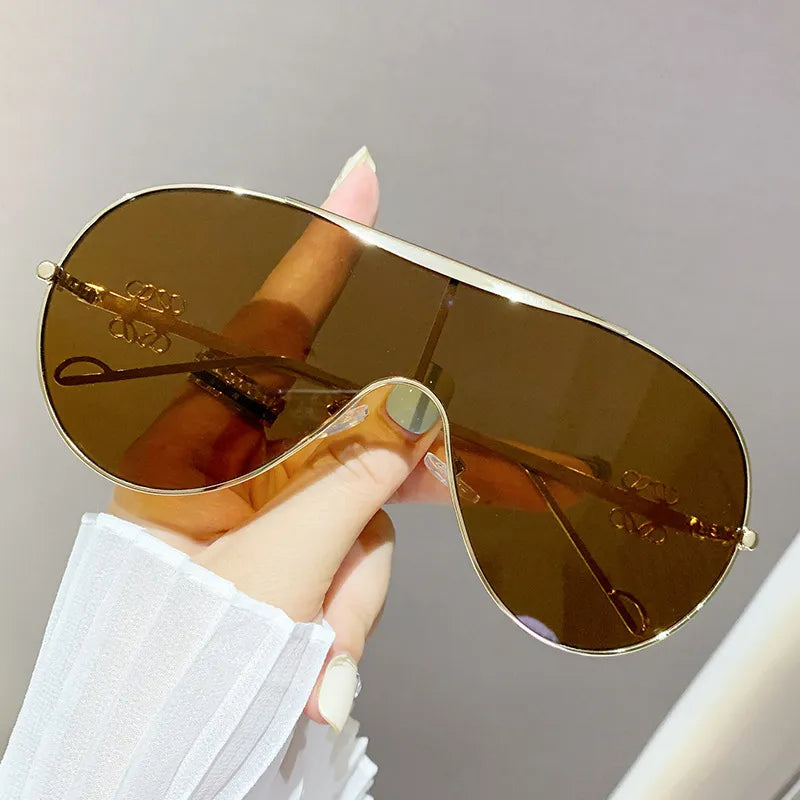 Aviator sunglasses with gold-tone frame and gradient amber-brown lenses
