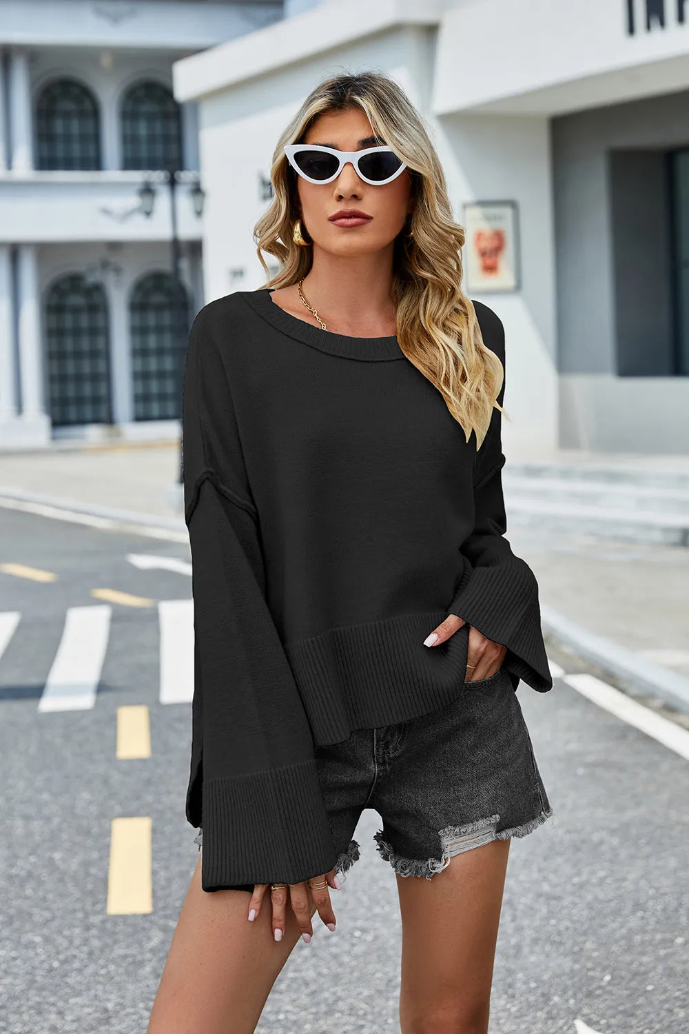 Black long-sleeve knit sweater with round neckline; ribbed hem and cuffs