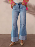 Light blue high-waisted flare jeans with distressed details and wide cuff hem