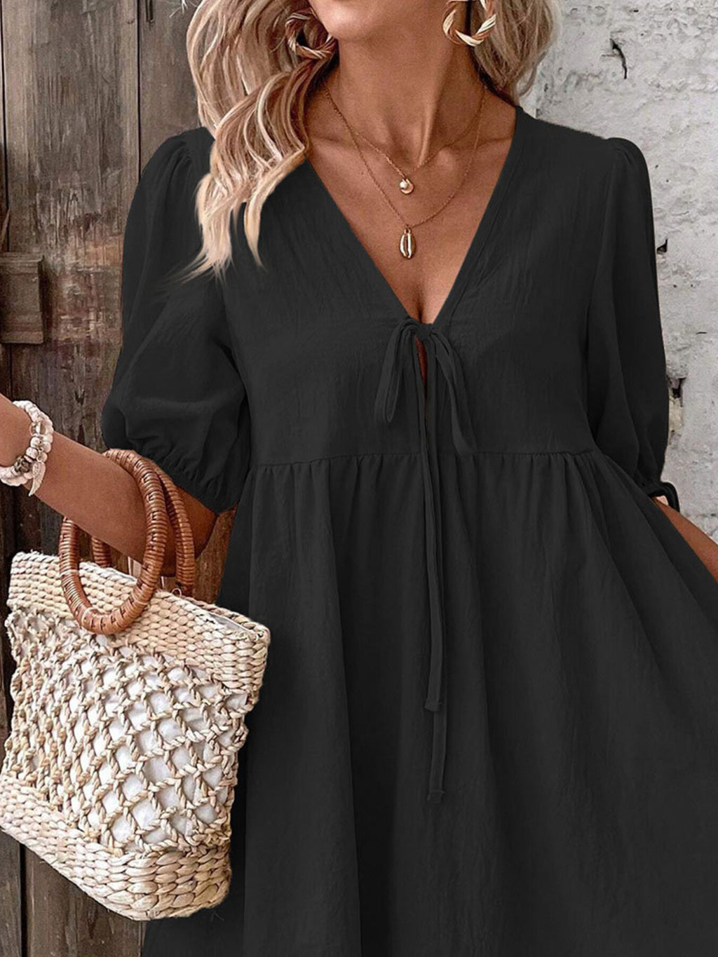 Black tie-front puff sleeve mini dress with gathered tiered skirt