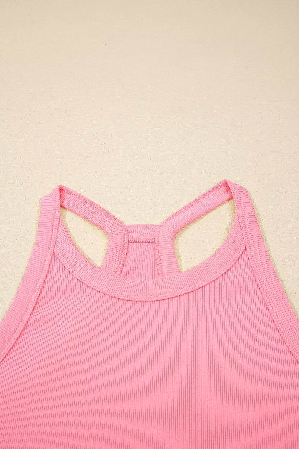 Dusty pink sleeveless cropped top with crisscross open-back strap detail