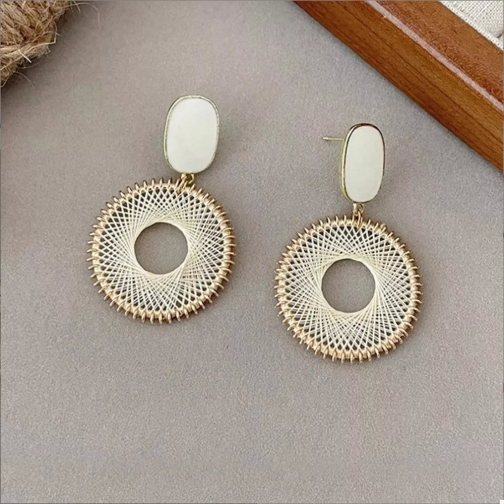 Gold-plated circle drop earrings with white oval caps and textured woven circular hoops