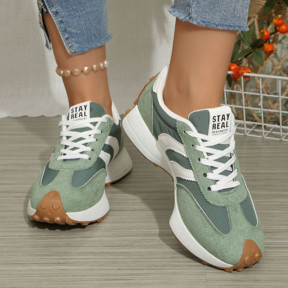 Green suede lace-up sneakers with white stripe panels, round toe, gum traction sole
