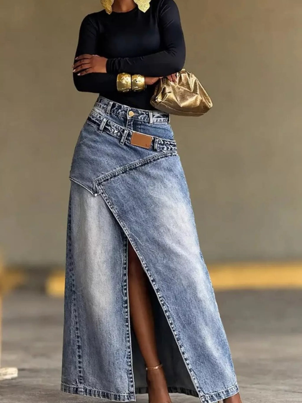 Blue high-waisted denim skirt with long front slit, belt loops, and single button