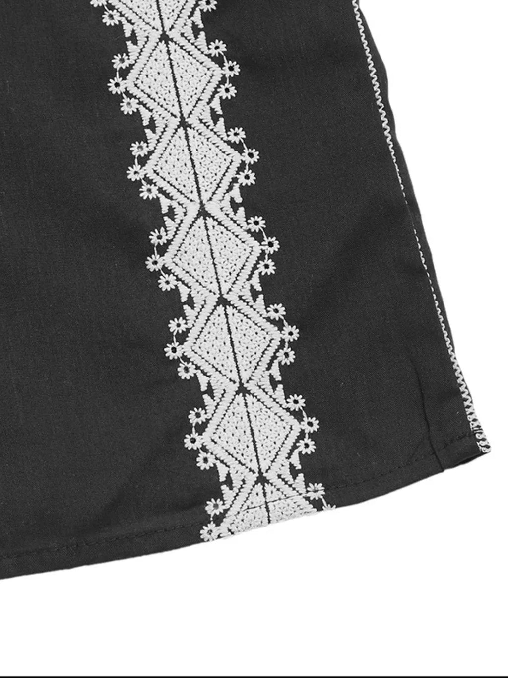 Black tank with white embroidered vertical panel trim along the side