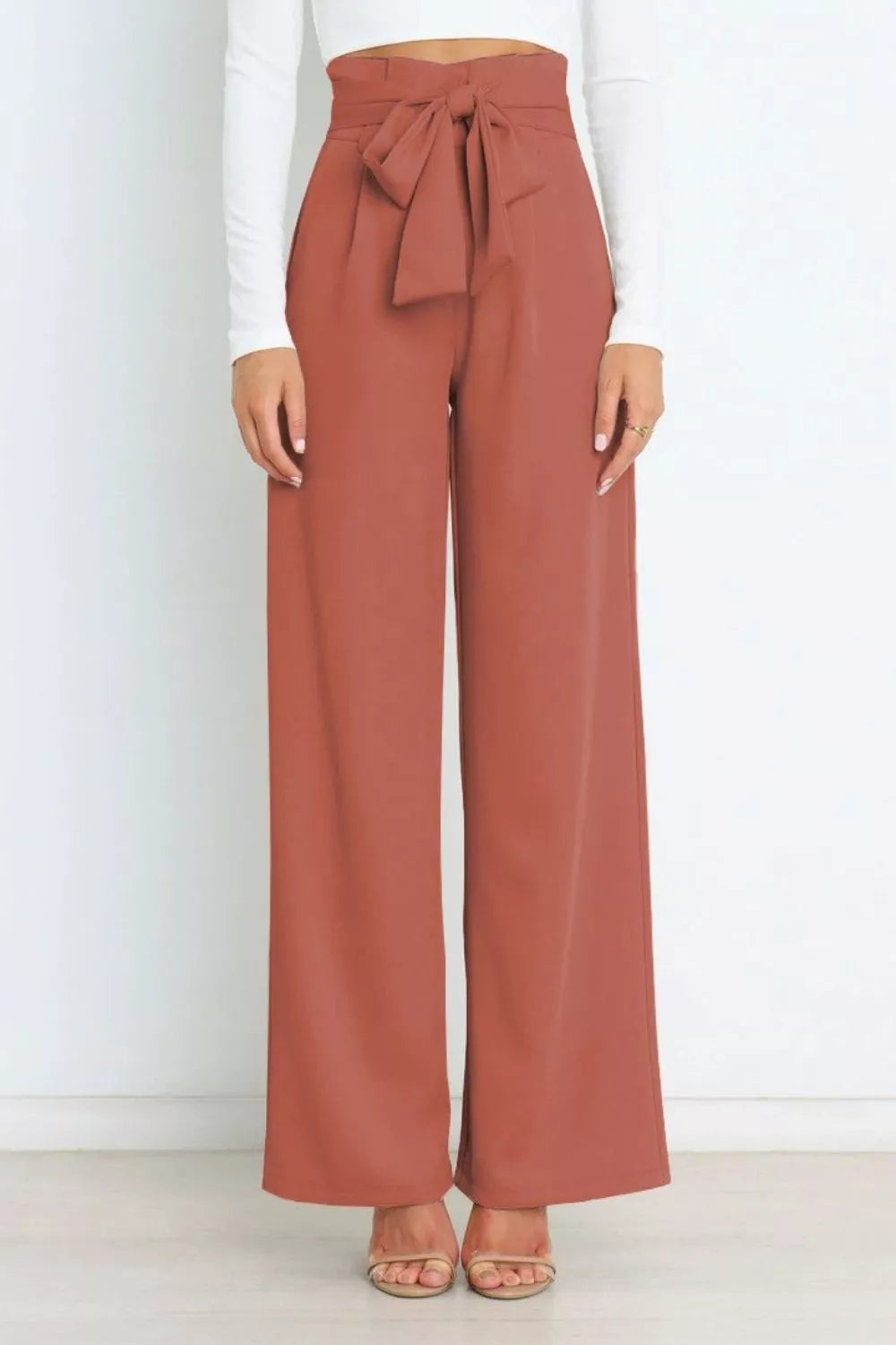 Brick red high-waist tie-front wide-leg pants with a tied bow at the waistband