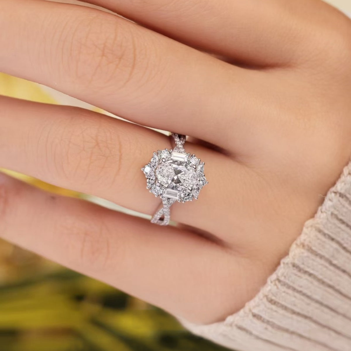 Close-up of moissanite halo ring on finger, round halo and prong-set center