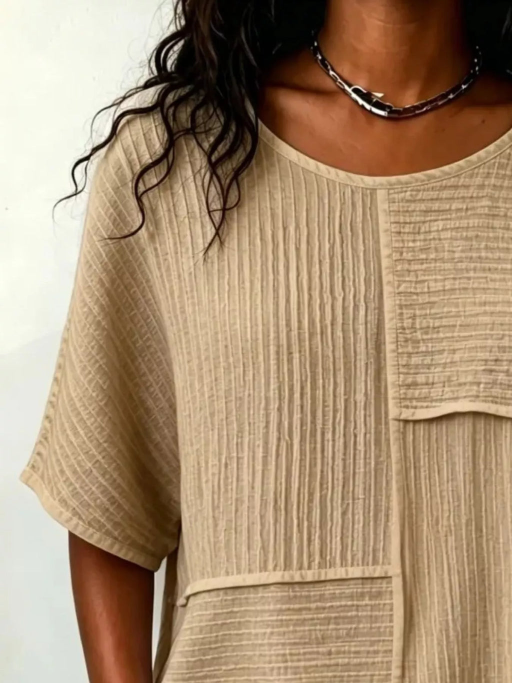 Khaki textured round-neck half-sleeve blouse close-up of seam and layered yoke