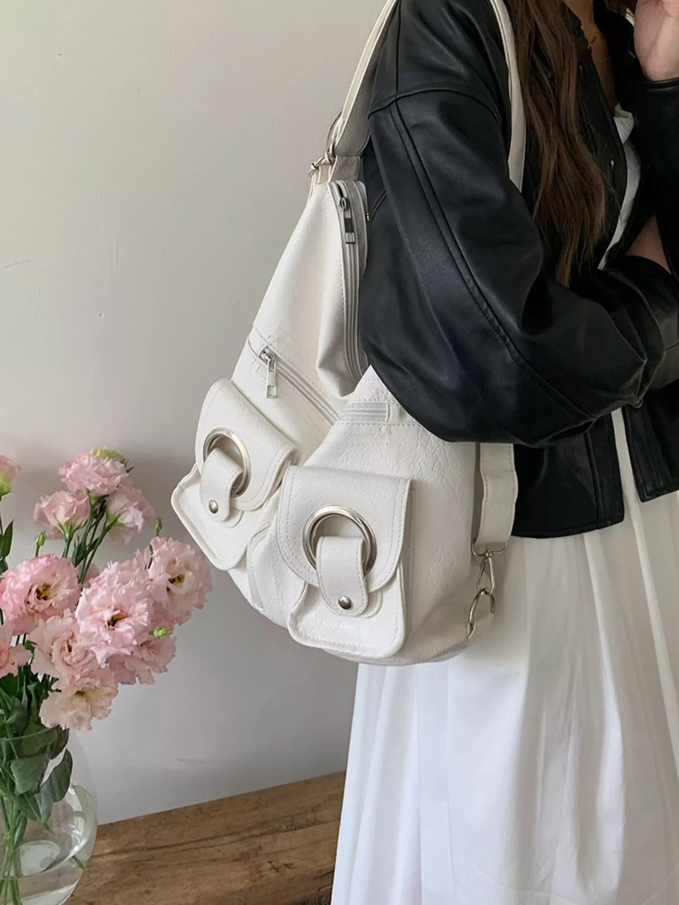 Convertible pocket handbag, white; side view with zip pocket and curved strap