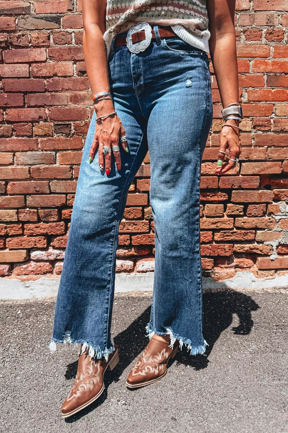 Front view of high-waist flare jeans in medium wash with frayed hem