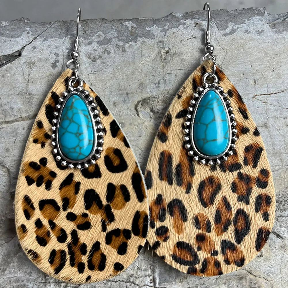 Turquoise teardrop earrings with leopard print dangles and ornate silver border detail