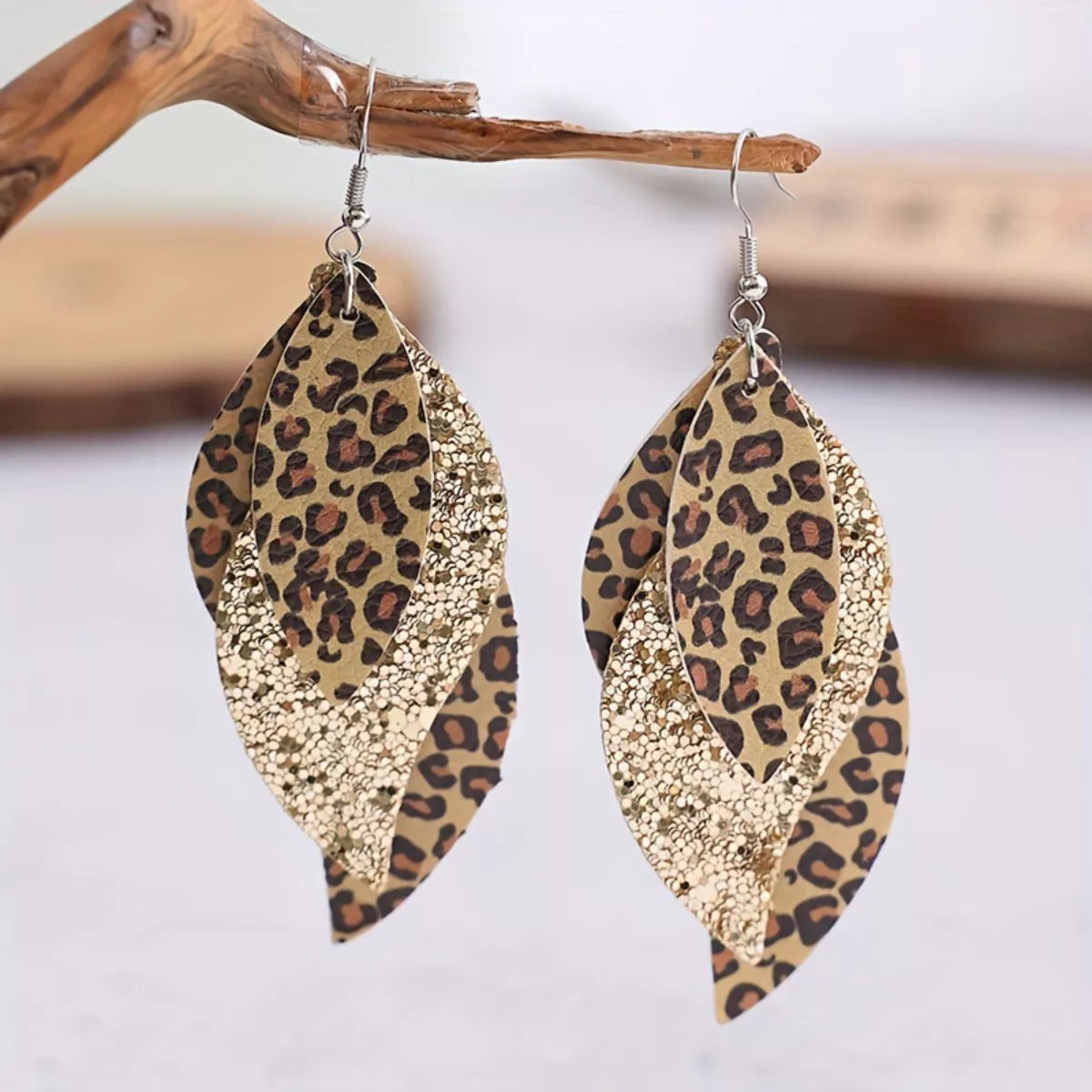 Gold-tone leopard print leaf drop earrings with glitter inset and fishhook backs