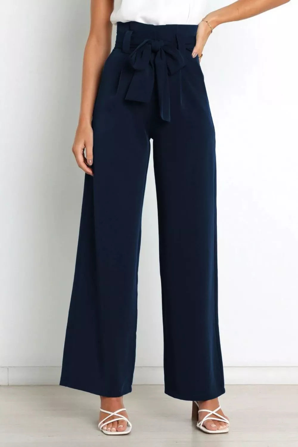 Dark navy high-waist wide-leg pants with oversized front bow and waist tie