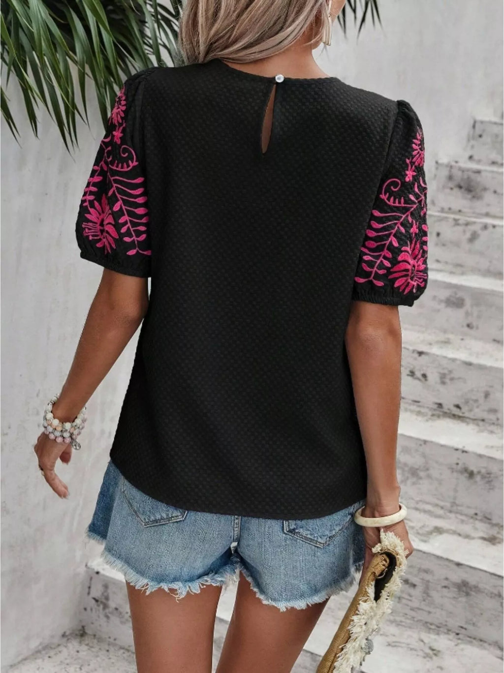 Black embroidered blouse, open-back keyhole detail with pink floral puff sleeves