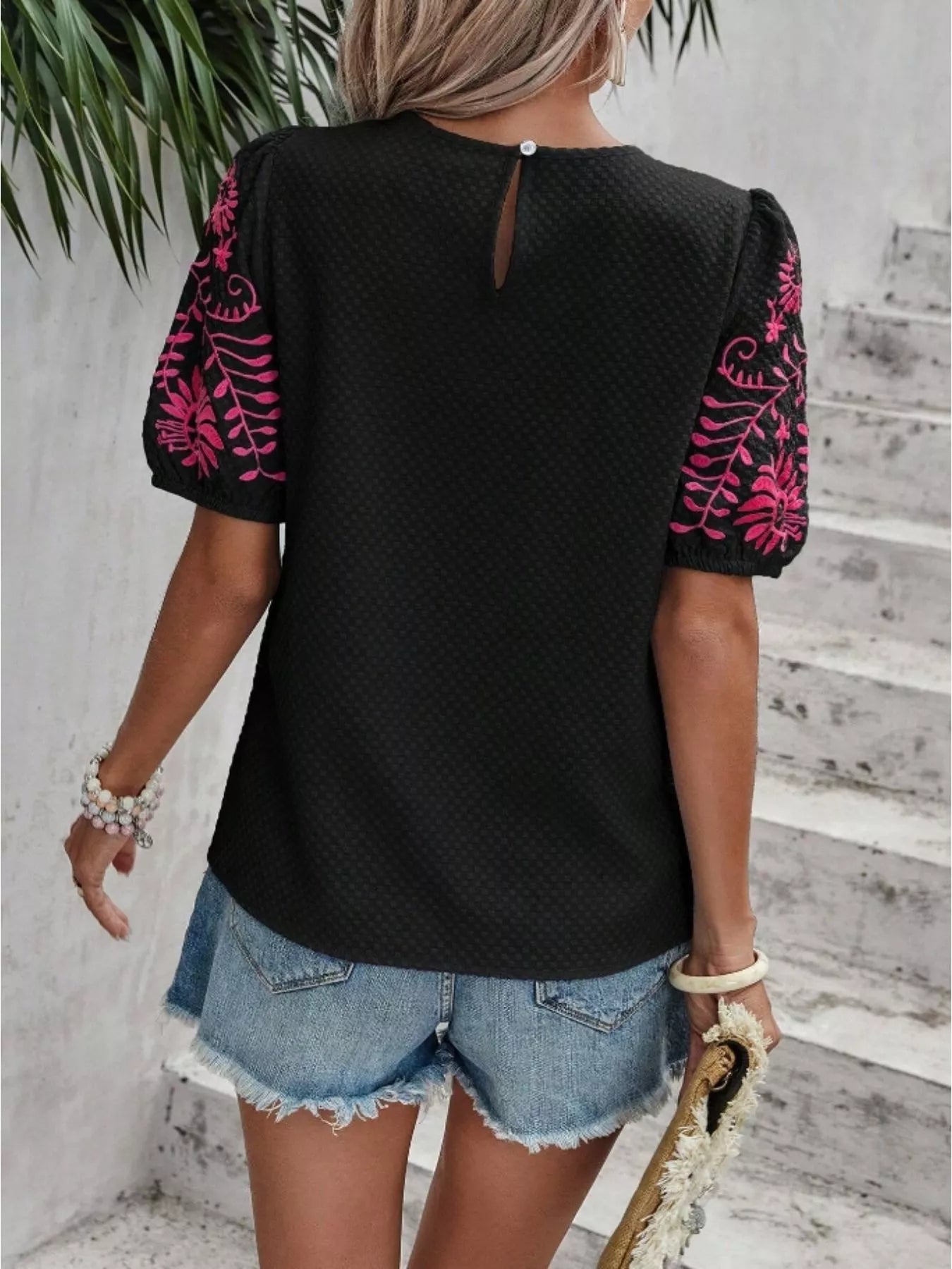 Black embroidered blouse, open-back keyhole detail with pink floral puff sleeves