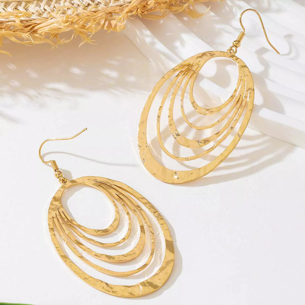 Gold layered hoop earrings, oval hoops with multiple curved bands around the opening
