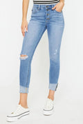 Light wash distressed cat whiskers button-fly jeans, cuffed hems with ripped detail