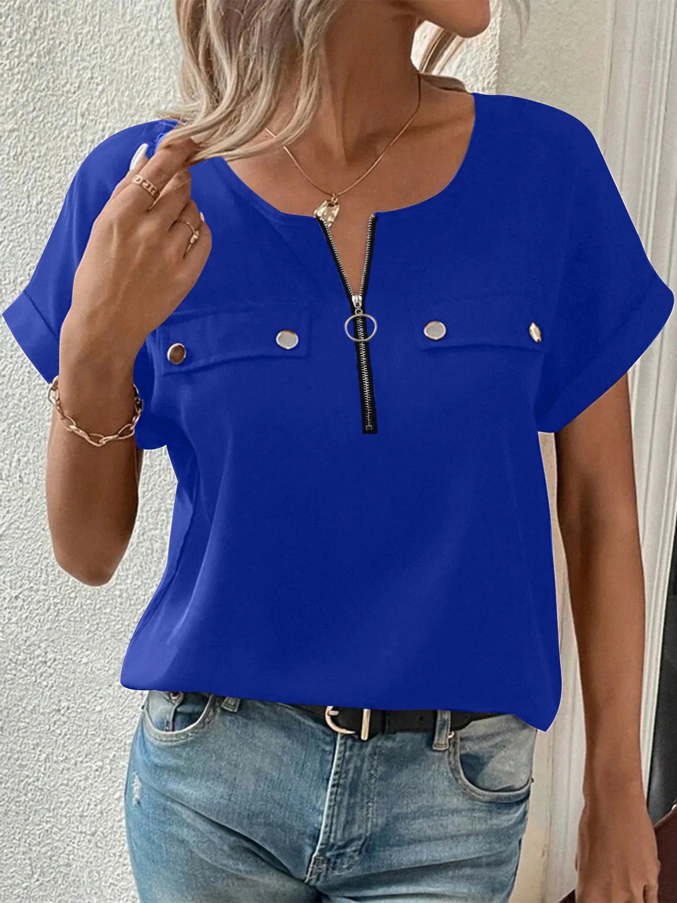 Blue short-sleeve blouse with front zipper and chest snap pockets