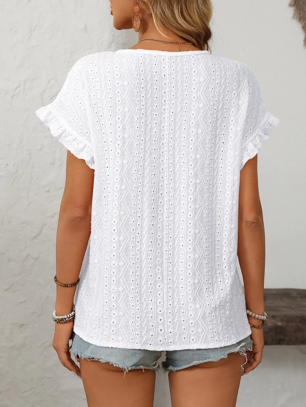 White eyelet short-sleeve top, back view with flutter sleeves