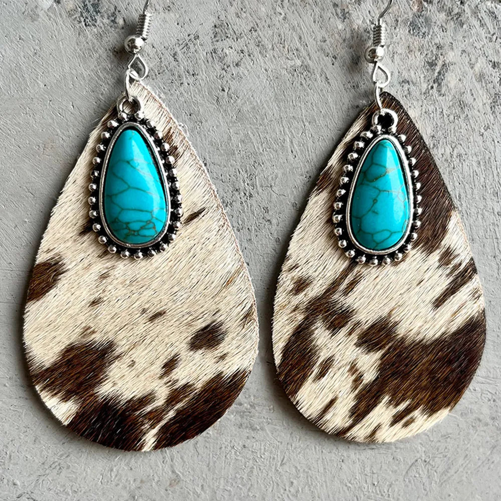 Turquoise teardrop earrings, cow print dangles with silver beaded trim around the stone
