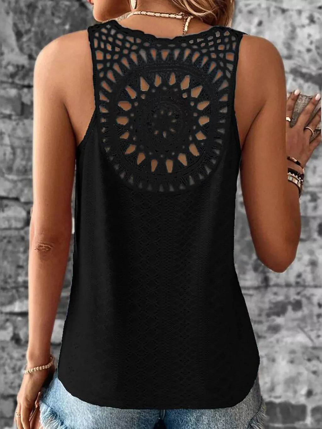 Black eyelet lace backless tank top with V-neck and circular lace yoke on back.