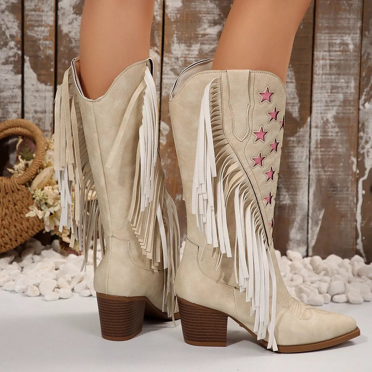 Ivory boots showing back seam and white tassel fringe over a brown block heel