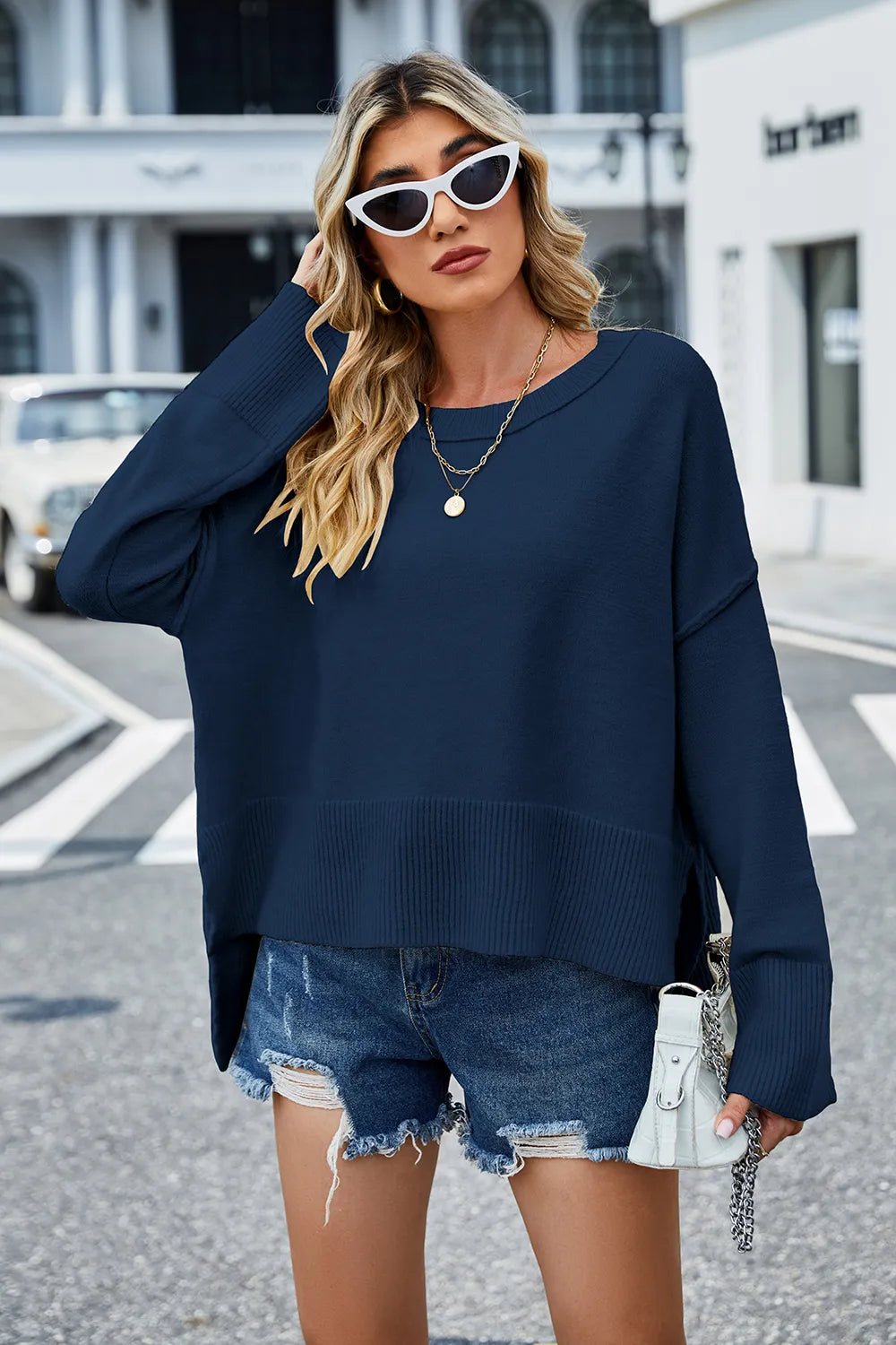 Front view: high-low slit sweater, navy crewneck with ribbed hem