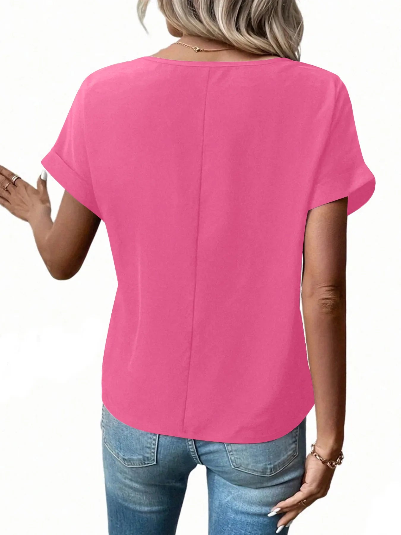 Back view of bright pink short-sleeve zipper blouse with center seam