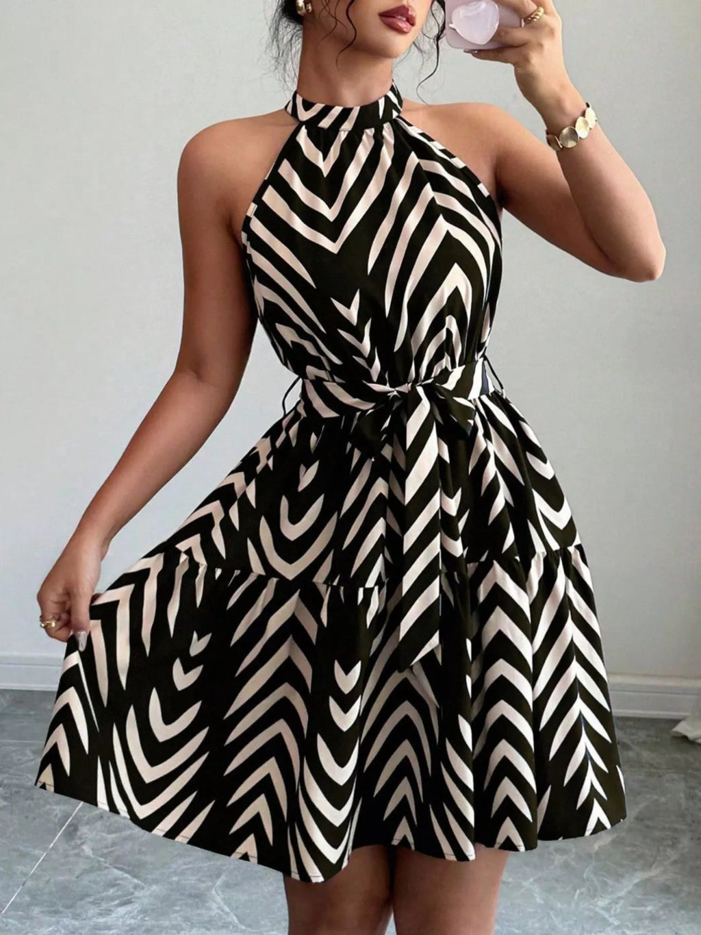 Black zebra-print halter neck dress with bow-tie waist and flared ruffle-hem skirt