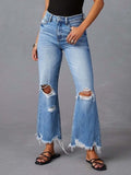 Light blue distressed flare jeans with raw hem and ripped knees, front view