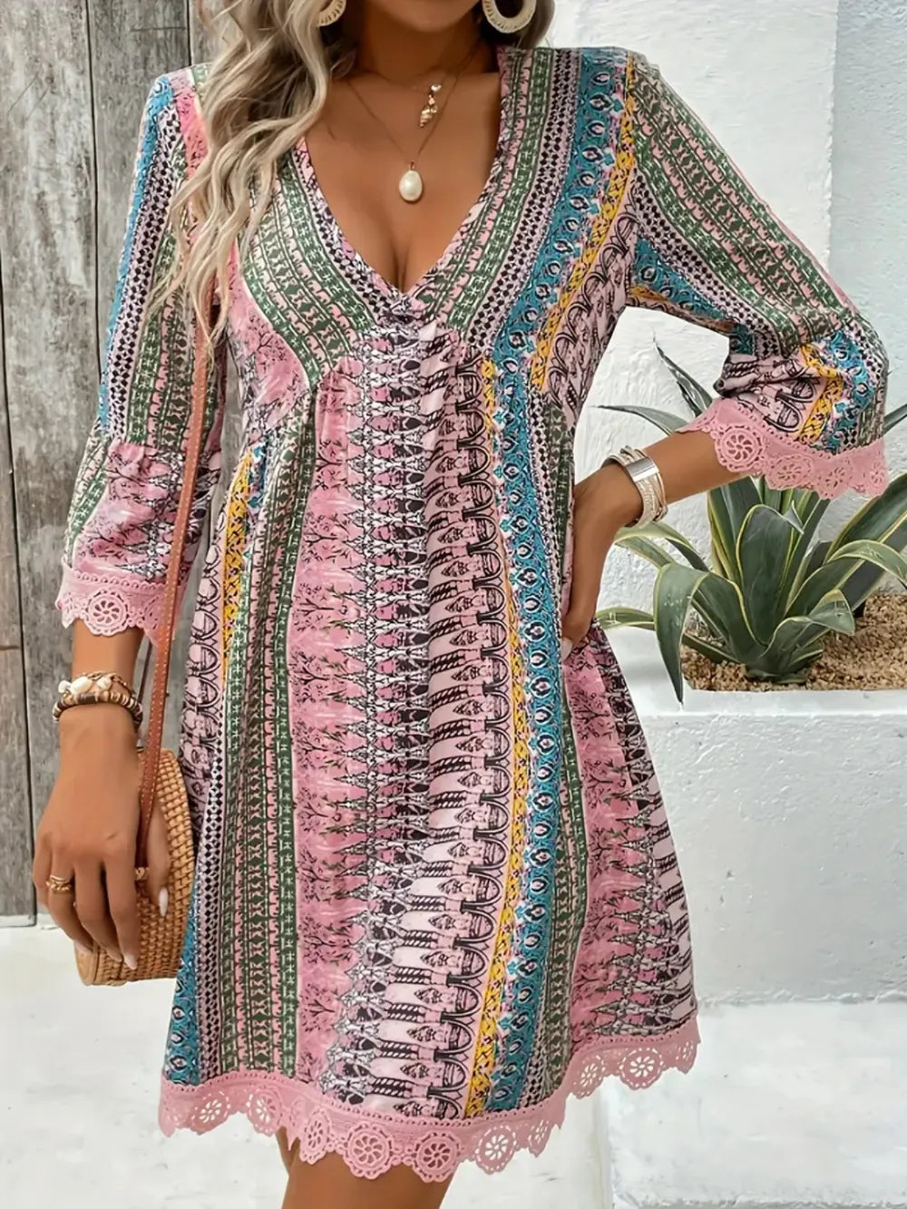Blush pink printed V-neck 3/4 sleeve dress with lace trim and corset crisscross