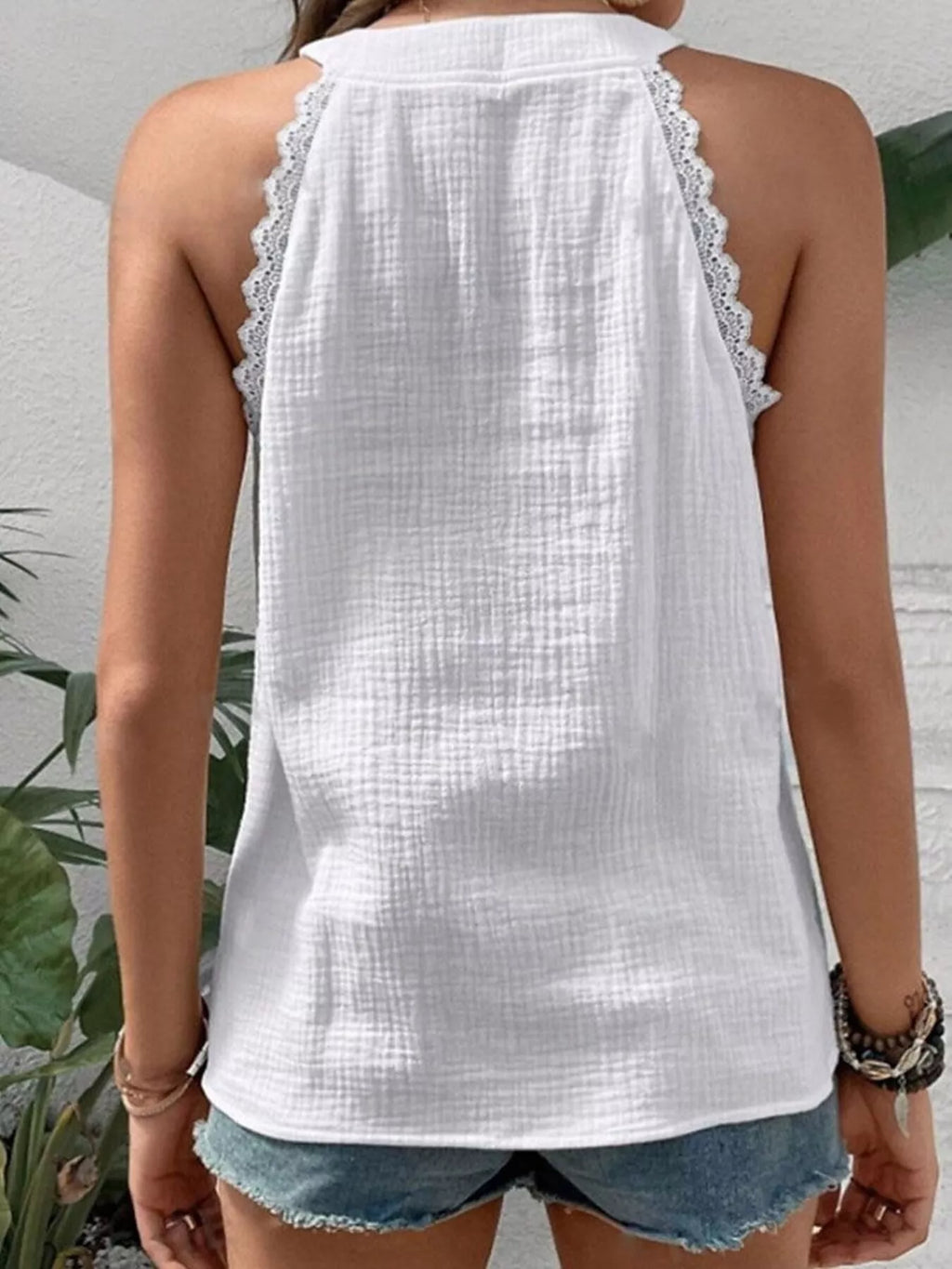 Back view of white textured tank with lace trim around shoulders