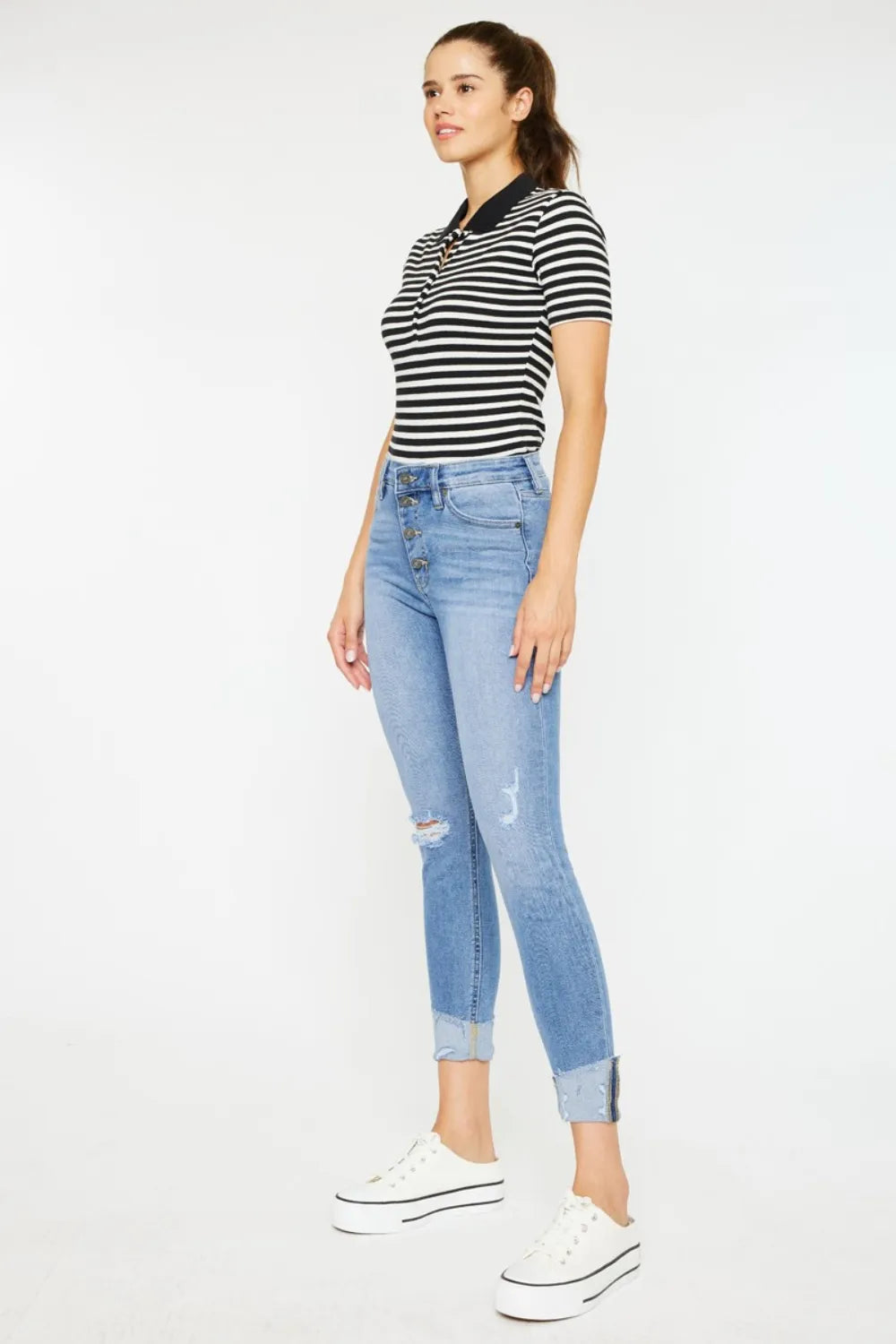 Light wash cat-whisker button-fly jeans with small knee rips and cropped cuffs
