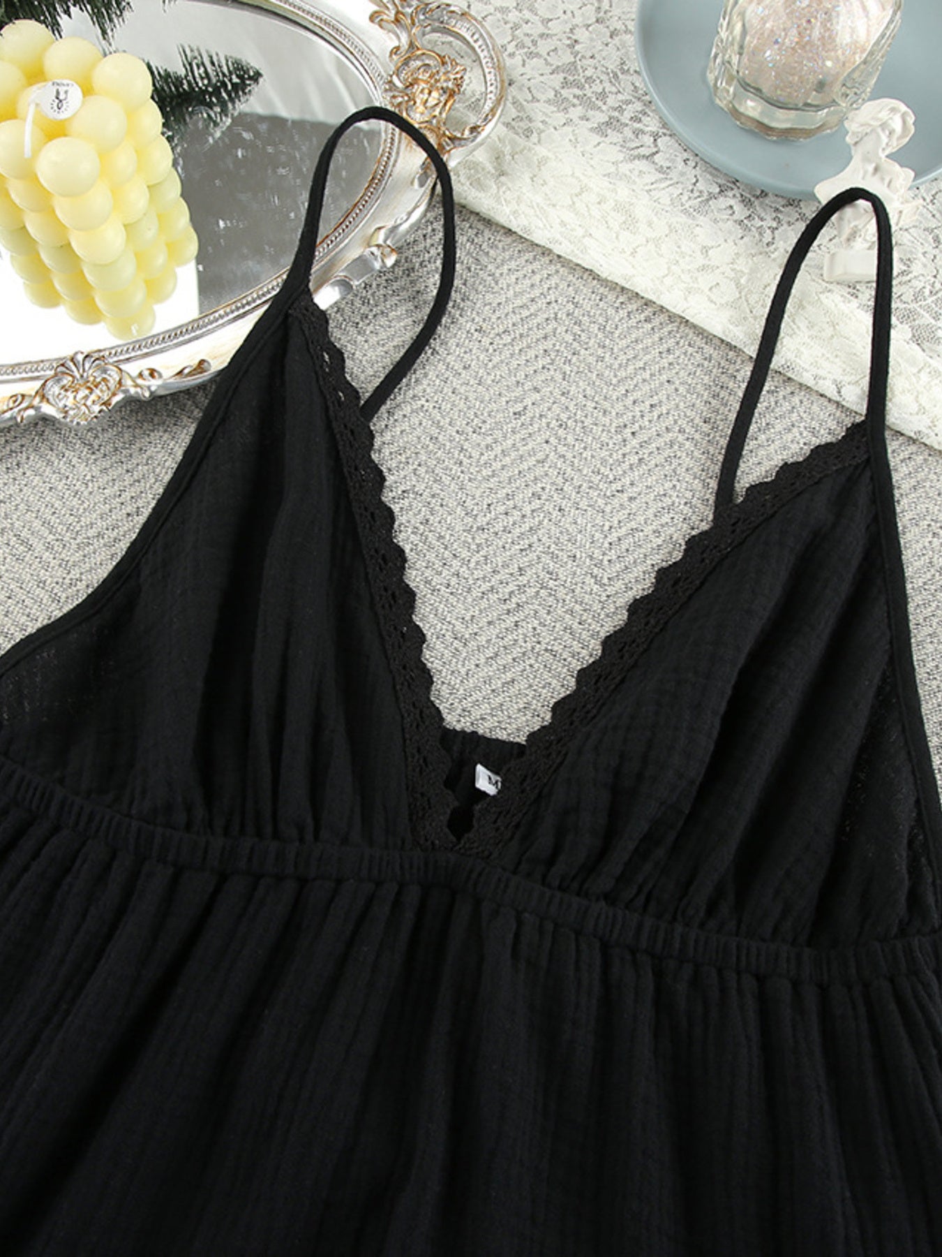 Black V-neck tiered mini dress with scalloped lace trim and thin straps