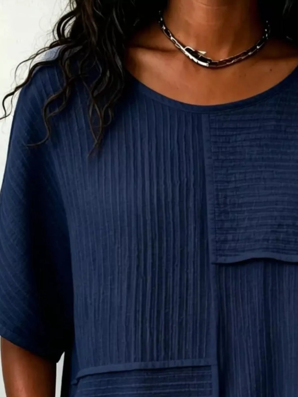 Textured navy blue round-neck half-sleeve blouse with vertical rib pattern and pocket panel