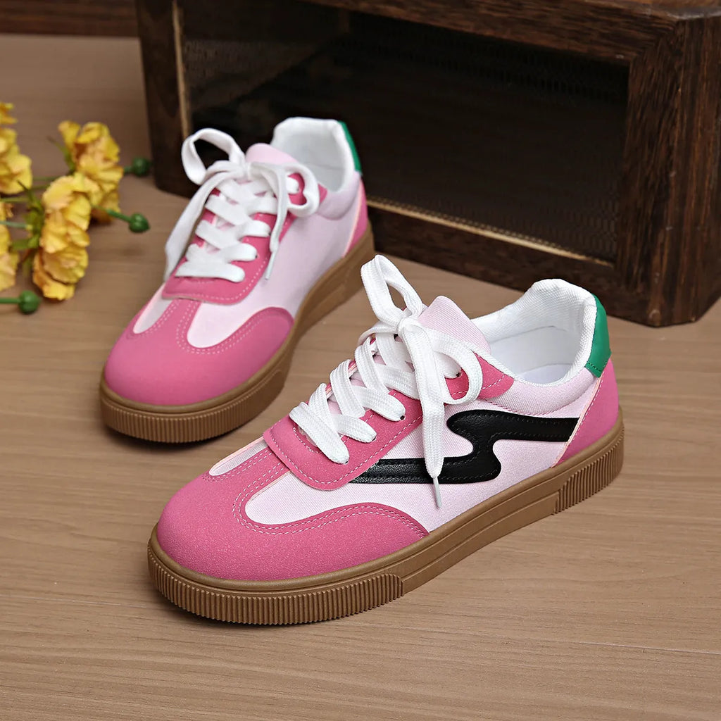 Pink lace-up sneakers with white laces, black side detail, and tan rubber sole