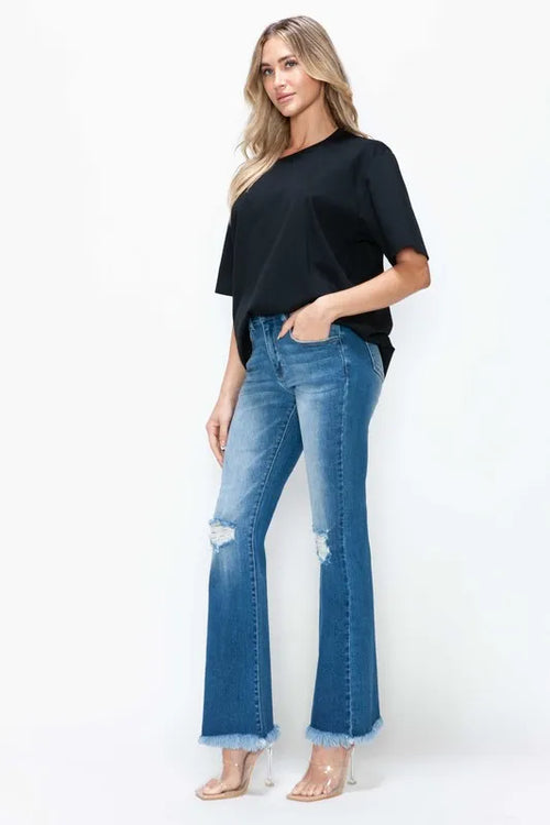 Women’s medium blue bootcut jeans with ripped distress and frayed raw hems