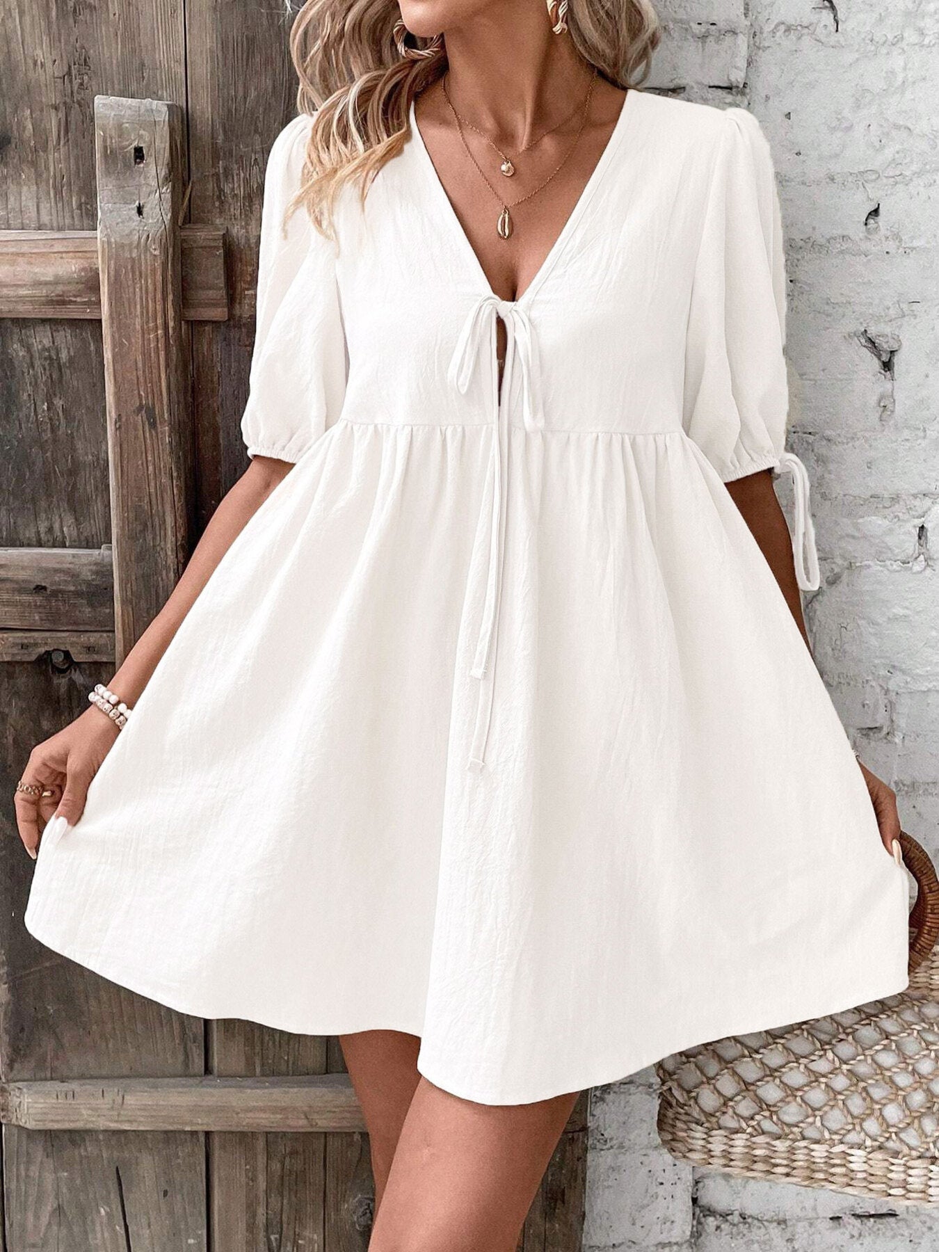 White tie-front V-neck mini dress with puff sleeves and gathered waist