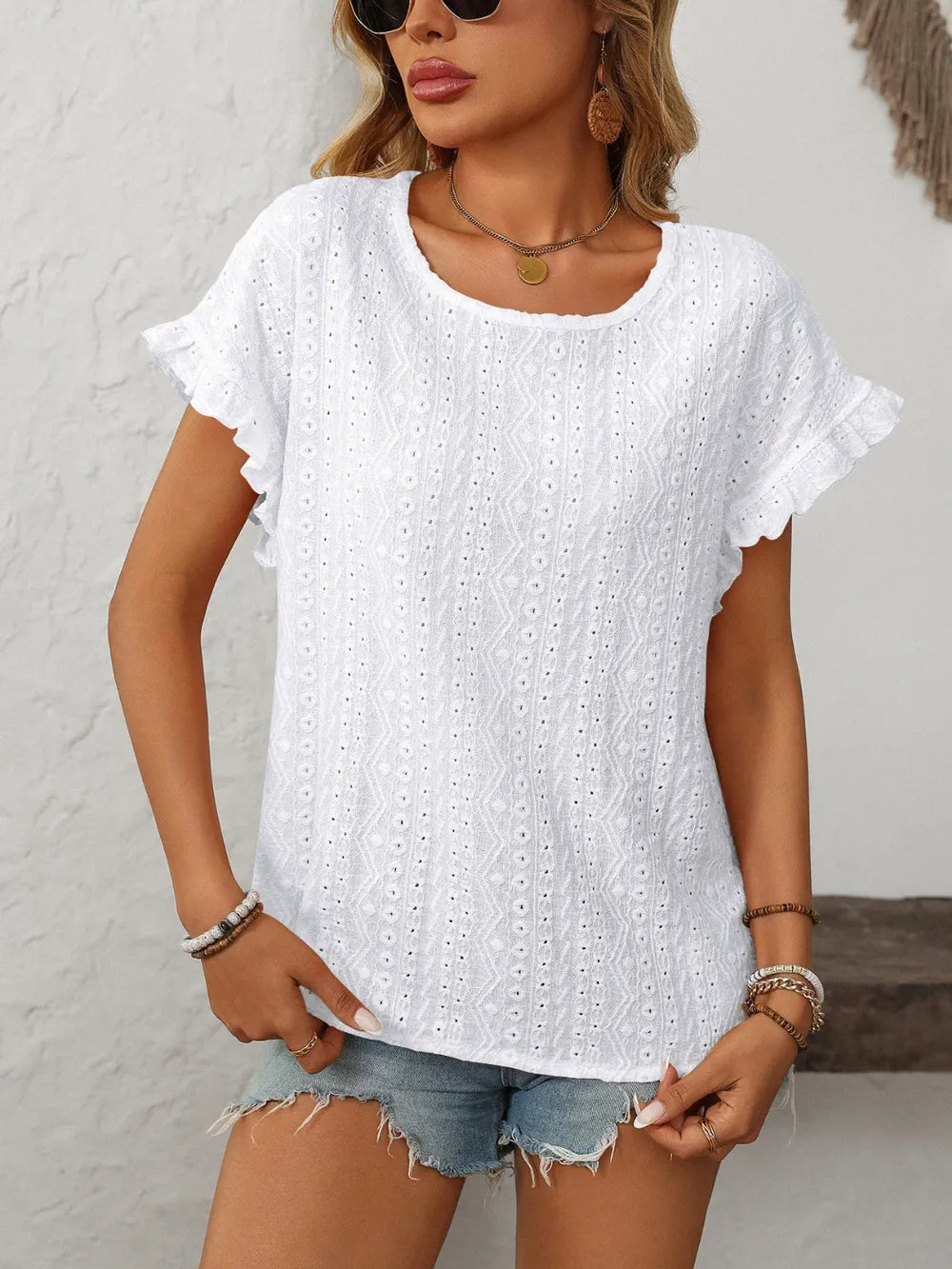 White eyelet short-sleeve top, round neck and flutter sleeves with eyelet texture