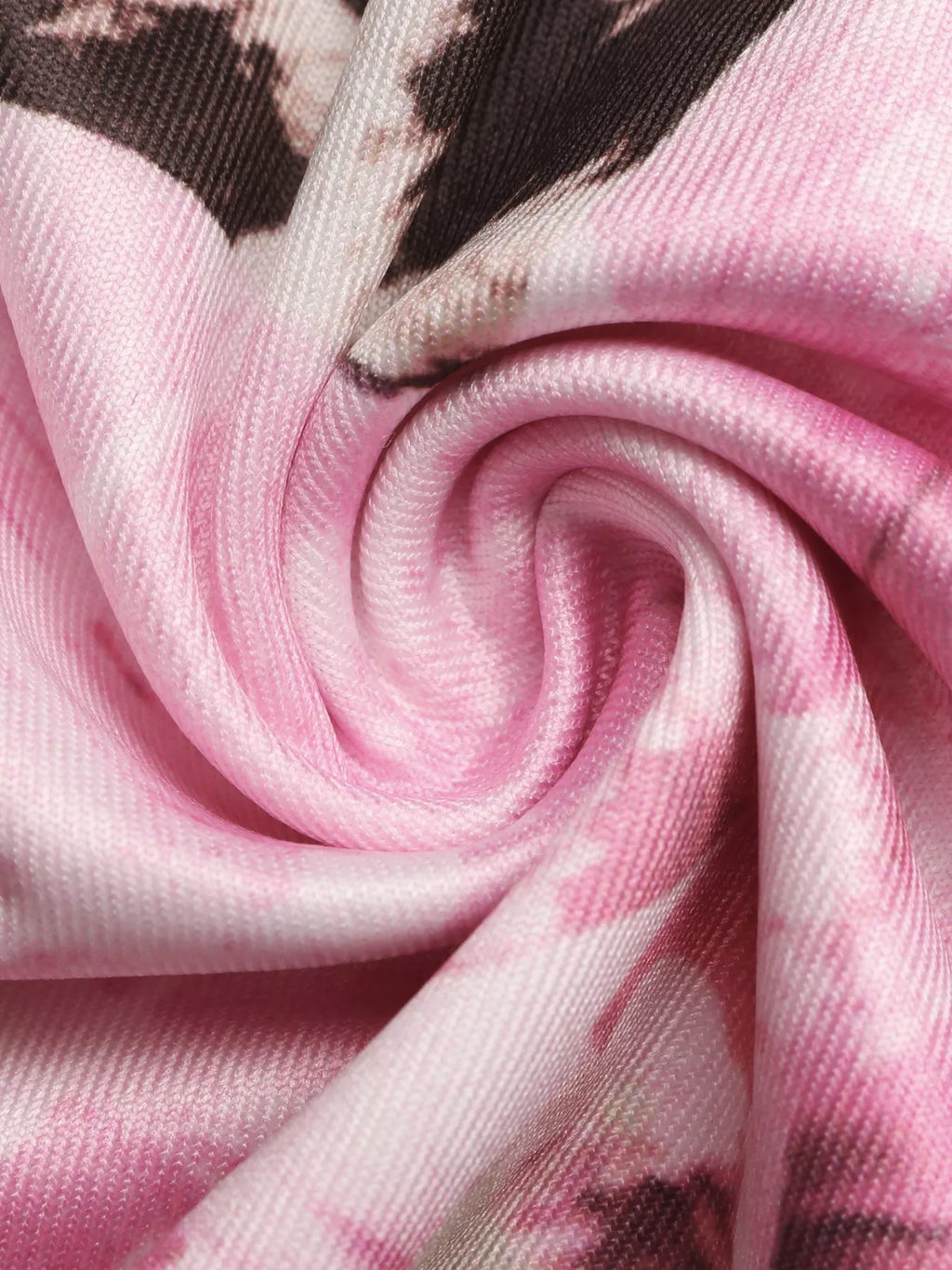 Pink leopard floral knit fabric close-up, smooth drape and stitching