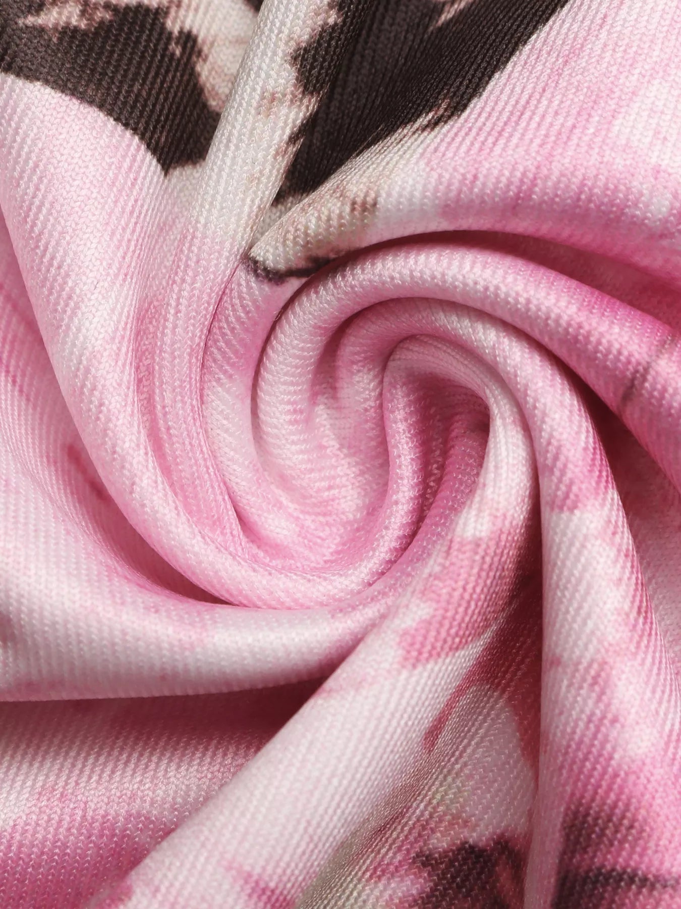 Pink leopard floral knit fabric close-up, smooth drape and stitching