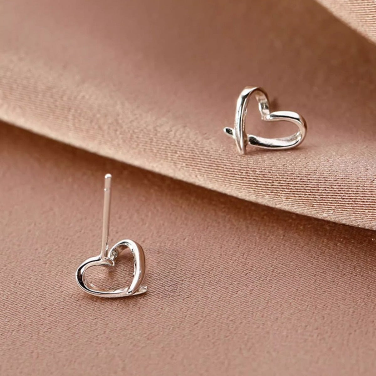 Silver heart-shaped studs with straight posts, heart outline front