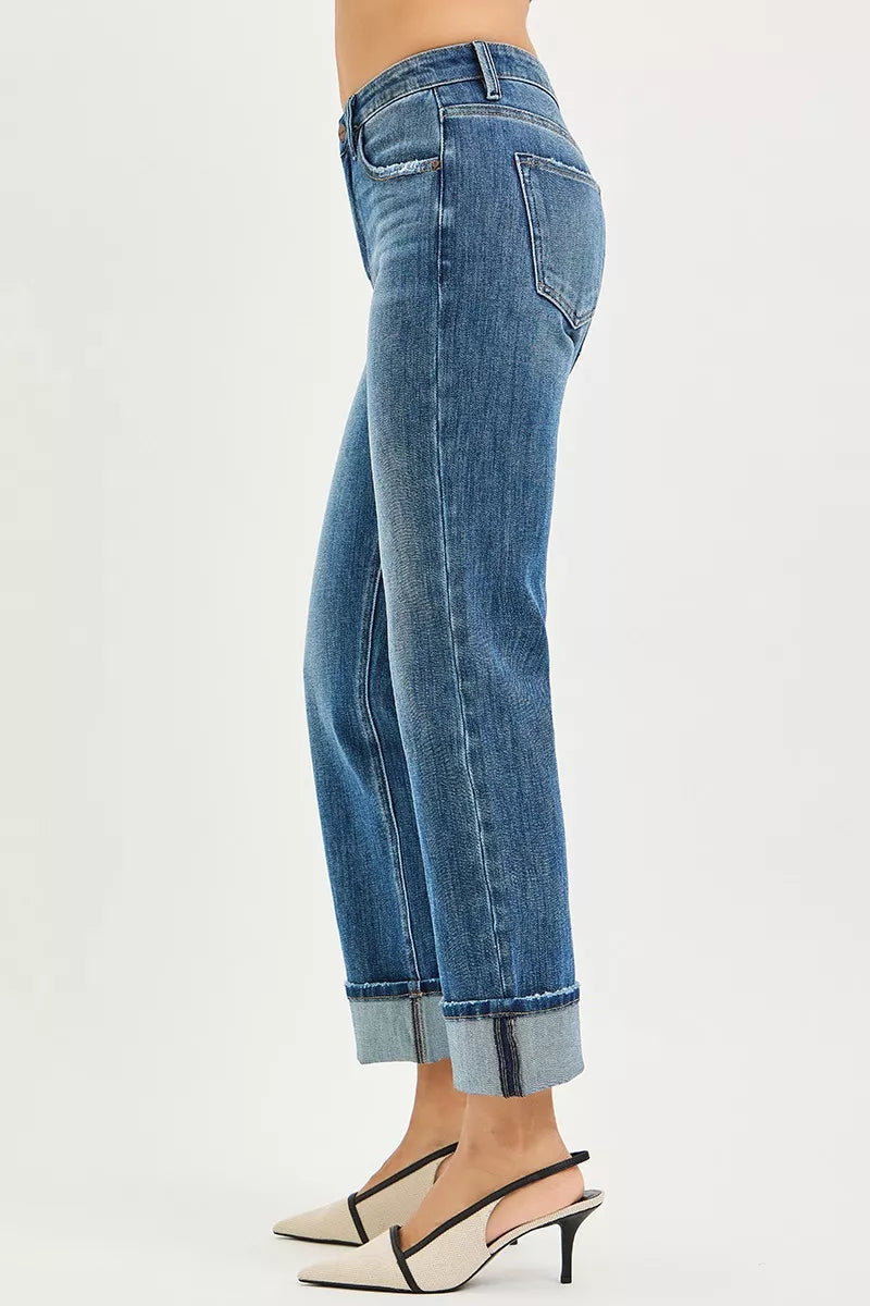Dark blue jeans with cuffed hem, side seam details, and belt loops