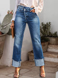 Medium blue straight jeans, stepped waistband, raw rolled cuffs, belt loops, button fly
